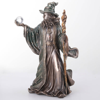 Wizard Holding Crystal Ball And Staff